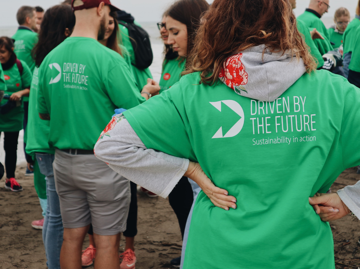 volunteers from carel industries at a beach clean-up of marine litter in chioggia