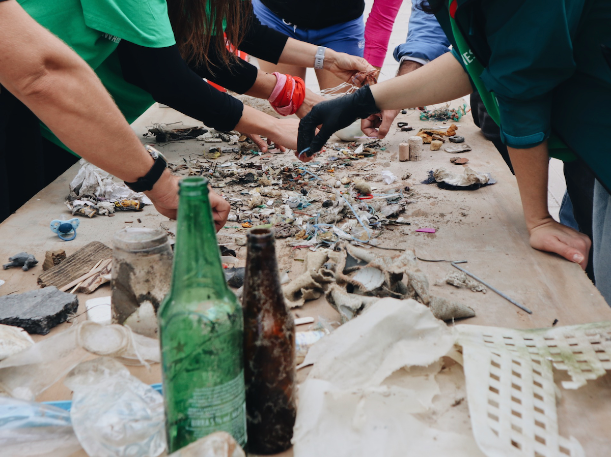 volunteers from carel industries at a beach clean-up of marine litter in chioggia