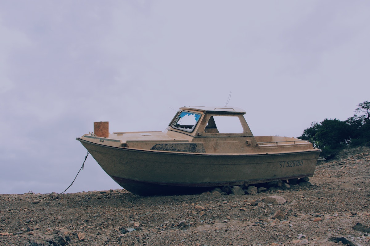 abaondoned boats in venice lagoon on a pebbled beach